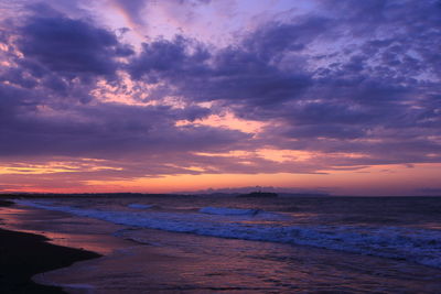 Scenic view of beach against sky during sunset