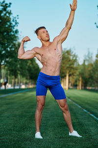 Full length of man exercising on field