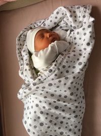 Cute baby girl lying on bed