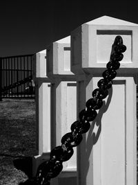 Close-up of chain against fence