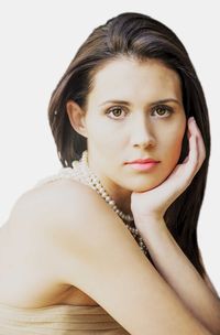 Portrait of beautiful young woman against white background