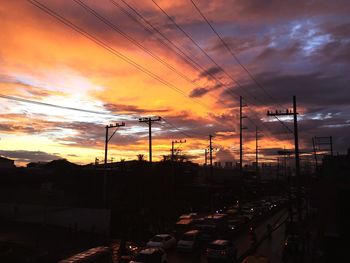 Silhouette city against sky during sunset