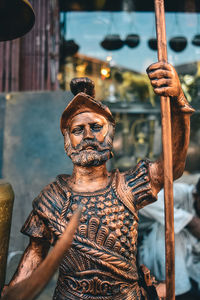 Close-up of statue against store