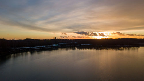 Scenic view of lake against sky during sunset