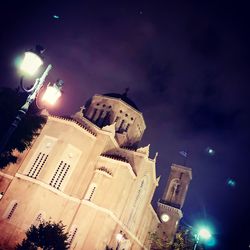 Low angle view of illuminated building against sky at night