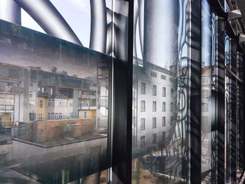 Low angle view of modern glass building in city