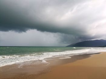 Scenic view of sea against cloudy sky