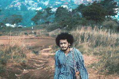 Portrait of afro young man standing on land