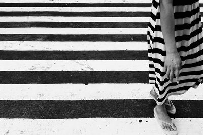 Low section of white zebra crossing on footpath