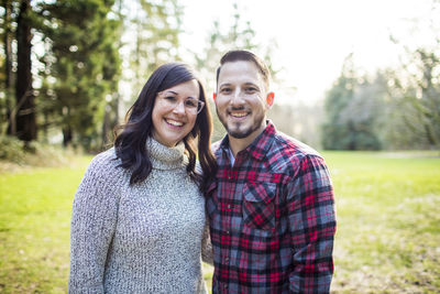 Portrait of attractive young millennial couple outdoors.