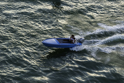 High angle view of man on boat in sea