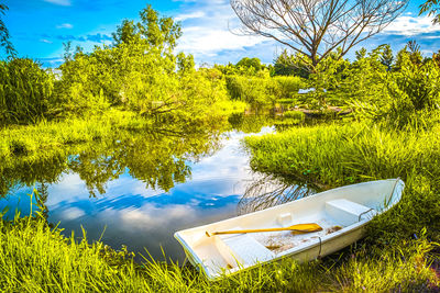 The beautiful landscape ofmall wooden rowing boat on a calm lake.