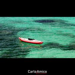 Man floating on sea against sky