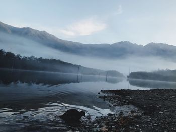 Scenic view of lake and mountains against sky