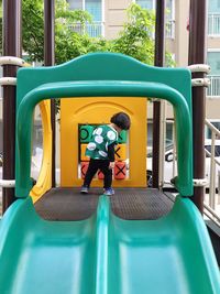 Rear view of girl playing tic-tac-toe in playground