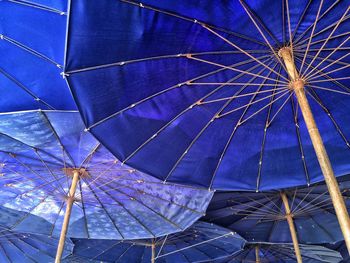 Low angle view of illuminated ferris wheel against sky