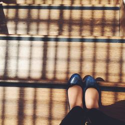 Low section of woman standing on tiled floor