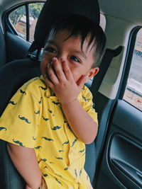 Smiling baby boy sitting in car