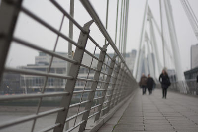 People walking on bridge in city