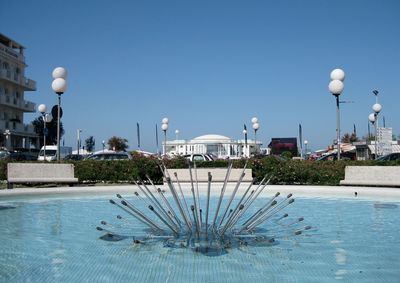 View of buildings against clear blue sky