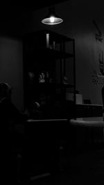 Rear view of people sitting on table at home