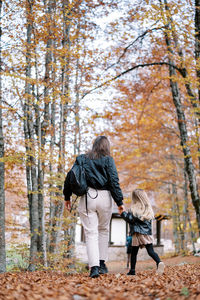 Rear view of woman walking in forest