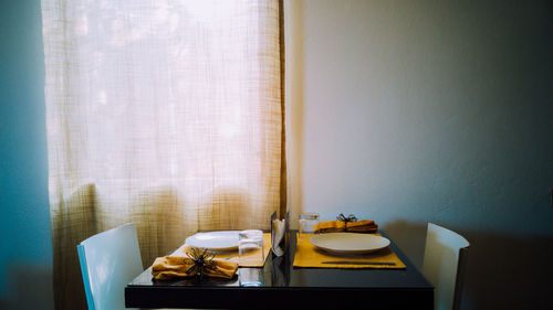 Empty chairs by dining table at home