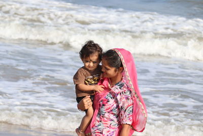 Little one years old boy portraits with mother in summer afternoon on beach chennai, marina beach