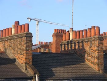 Chimneys in city against clear sky