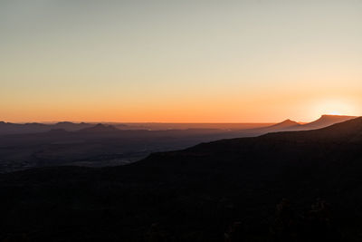 Scenic view of silhouette mountains against sky during sunset