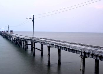 Pier over sea against clear sky