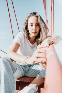 Portrait of young woman sitting on hammock