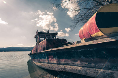 Abandoned boat against sky