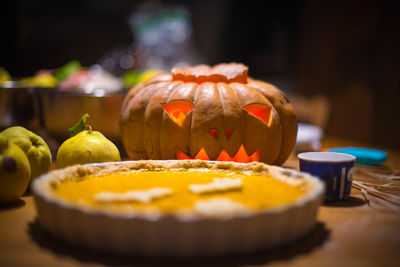 Close-up of cake with pumpkin on table