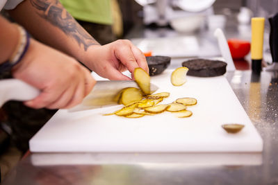 Cropped hand of person preparing food