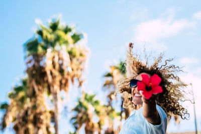 Smiling woman showing flower