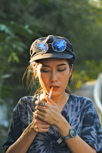 Portrait of young woman holding plant