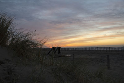 Scenic view of beach against sky during sunset