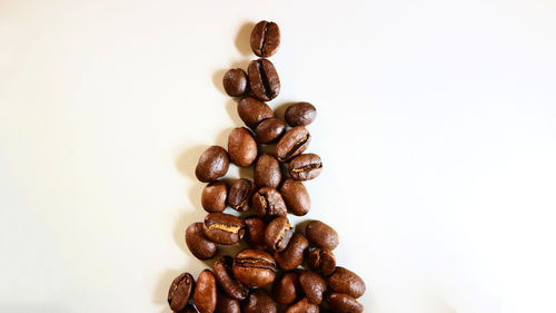 Close-up of coffee beans against white background