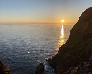 Scenic view of sea against clear sky during sunset
