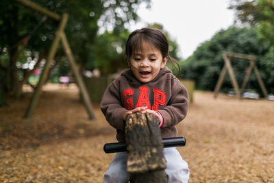 Portrait of smiling boy playing on field