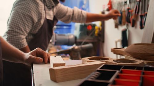 Midsection of man working in workshop