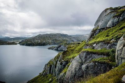 Scenic view of sea and mountains against sky