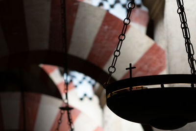 Low angle view of lighting equipment hanging in building