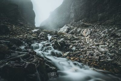 Scenic view of waterfall against sky