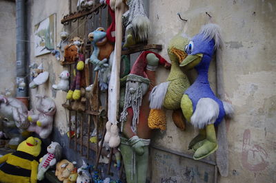 Various abandoned toys hanging on wall