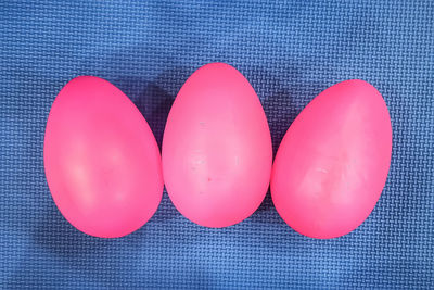 High angle view of pink balloons against blue background