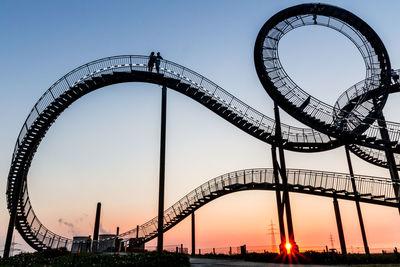 Low angle view of rollercoaster against clear sky