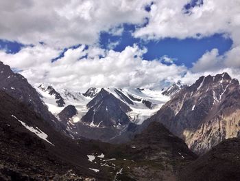 Scenic view of mountains against cloudy sky