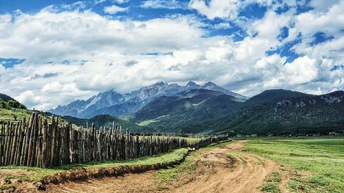 Scenic view of landscape against cloudy sky